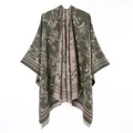 Detailed view of reversible olive green poncho with floral bird pattern and fringe. - Flower And Bird Short-bearded Shawl (green) / 130x150cm