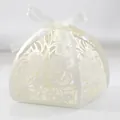 Elegant white laser-cut wedding candy box with intricate floral pattern and ribbon - Ivory