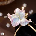 Close-up macro shot of elegant vintage enamel water lily brooch with pearlescent finish - Pink