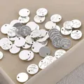 Detail view of round silver jewelry tags with "Hand Made" engraving for DIY crafts. - 68# Thick Silver Round [1 Piece] A1-503 (approx. 9.2mm)