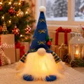 Handcrafted blue knitted Christmas gnome figurine with glowing warm LED beard for holiday decor - Blue Bow