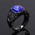 Close-up view of black titanium ring with a large blue gemstone and Masonic engraving - Black/Blue Zirconia
