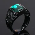 Close-up of men's black ring with green gemstone and engraved Freemasonry square and compass - Black/Green Zirconia