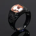 Close-up of a black titanium steel ring with an orange gemstone and Masonic symbol. - Black Champagne Rhinestones