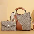 Detailed view of the printed pattern and metallic logo on the brown handbag set - With Small Pouch / Brown