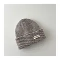 Close-up of the soft gray ribbed knit texture and label on this warm winter baby beanie - Kids / Oatmeal