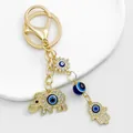 Detail view of a gold-toned evil eye keychain with rhinestone elephant and Hamsa hand charms - Gold Elephant Hamsa Hand Motif (8844)