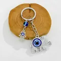 Detailed view of silver elephant keychain with blue evil eye and Hamsa hand charms. - Silver Elephant Hamsa Hand Motif (9696)