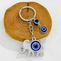 Close-up of a silver elephant keychain with vibrant blue nazar evil eye charms - Silver Elephant Nazar Motif (9697)