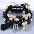 Set di braccialetti di perline multistrato bohémien con ciondolo happy e nappa nera chic. - Nero