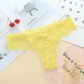 Detail shot of yellow floral lace thong with scalloped edges and transparent texture - One Size / Yellow