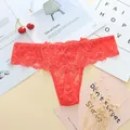 Close-up detail of exquisite red lace floral pattern on sexy low waist thong panties - One Size / Watermelon red