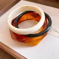 Close-up detail showing the textures of a bohemian three-piece resin bracelet set - Three-Piece Set / Brown Black & Beige (Set Of 3)