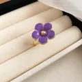 Detailed view of an elegant purple enamel flower ring with a gold-tone finish setting - Ring / Purple