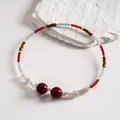 Macro view of vintage beaded choker with red acrylic stones and silver flower accents - Choker Clavicle Chain (HN13032) / Red-Coffee-White