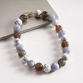 Primer plano de grandes cuentas de acrílico con efecto mármol en un collar llamativo - Blanco-Gris