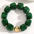 Close-up of vintage green acrylic cube beads and polished gold sphere on elastic bracelet - Dark Green (11263)