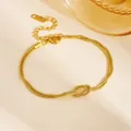 Close-up of gold layered stainless steel snake chain bracelet with knot detail - Double Layer Bracelet (E610) / Gold