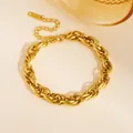 Close-up detail of a gold-plated layered twisted link stainless steel fashion bracelet - Large Round Rope Bracelet (E809) / Gold