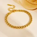 Close-up of golden braided wheat chain bracelet in durable stainless steel finish - Small Square Rope Bracelet (E712) / Gold