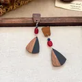 Detailansicht der Retro-Ohrringe aus Holz und schwarzem Harz mit roten Perlen - Teardrop Patchwork / Schwarz