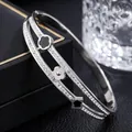 Close-up of elegant double-layer titanium steel bangle with clover charms and pavé stones - Clover Rhinestone Style (41-A-8) / Steel