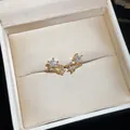 Close-up detail of 18k gold plated star ear clips with sparkling cubic zirconia stones - Star / Gold