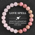 Gros plan détaillé du bracelet en quartz fraise rose avec le texte romantique LOVE SPELL - LOVE SPELL-F
