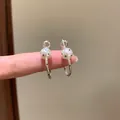 Close-up of silver C-shaped hoop earrings featuring white polka dot bead charms. - 3cm (82#) / Silver (Polka Dot Decoration)