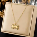 Detailed view of a gold-plated bone pendant necklace with sparkling crystal inlay. - Cartoon Bone Rhinestone Inlaid Pendant (N4508)