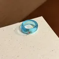 Detail shot of a transparent blue resin ring with a sparkling pink rhinestone inlay - Blue