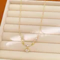 Detailed view of gold plated necklace with round zircon pendant in beige jewelry box - Round Pendant Style (Gold Plated) / Gold