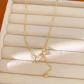 Close-up view of an elegant gold butterfly necklace with zircon and shell pendants on display - Butterfly Style (Real Gold Plated) / Gold