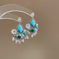 Close-up of Bohemian turquoise tassel earrings with rhinestones and floral accents - 1# Silver Earring Post-Gold-Blue