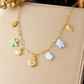 Close-up of gold-plated stainless steel necklace with colorful sea shell and turtle charms. - Seven Marine Theme Pendant Collection (N4500)