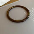 Amber marbled acrylic bangle bracelet with a minimalist thin round profile design - Simple Round Style (50#)