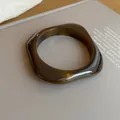 Elegant tortoiseshell acrylic square bangle with a translucent amber marbled finish - Wavy Square Style (55#)