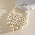 Elegant vintage layered white pearl fringe necklace and earrings set on textured stone - Necklace and Earring Set / White
