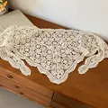 Detailed close-up of a white crocheted lace triangle waist scarf with floral patterns - Crochet Floral Scarf / Beige