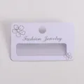 Detail view of white frosted PVC earring display card with silver floral pattern - 5cm*3cm / Fashion Jewelry Style / Frosted White