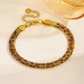 Macro view of gold PVD stainless steel snake chain bracelet with leopard print pattern - Leopard Style (D708) / Gold Leopard