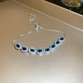 Elegante pulsera plateada con brillantes circonitas ovaladas azules y cierre ajustable. - Estilo 31# Azul Ovalado