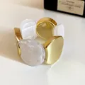 Close-up detail of a modern irregular geometric bangle featuring gold and white marble resin - 2# Elastic Cord Bracelet / Gold-White