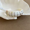 Elegant white marble resin open cuff bracelet with stylish silver metallic studs - Style 57