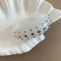 Chunky white acrylic open cuff bracelet with silver metallic studs variant, boutique style - Style 58
