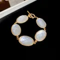 Elegant gold-tone bracelet featuring five faceted white oval stones and a toggle clasp - 77# Bracelet