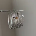 Vue détaillée du bracelet multicouche argenté Y2K avec breloques étoile et lune - Style 10 Bangle / Seize Pièces / Argent