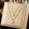 Close-up of layered gold necklace featuring sparkling star pendants on jewelry box - Double Layer Star Snake Chain Choker (N4504)