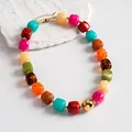 Close-up of vibrant marbled acrylic beads on a chunky geometric collar necklace. - Necklace / Gold-Multicolor