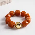Chunky marbled orange acrylic bead bracelet with large gold-tone statement metal ball - Bracelet / Gold-Brown